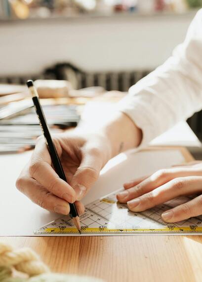 Person using professional measurement ruler on paper with millimeter precision in design work